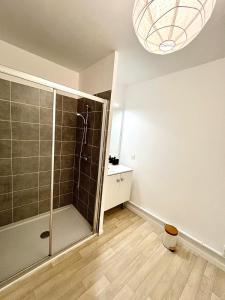 a bathroom with a shower with a glass door at Villeneuve, in Villeneuve d'Ascq