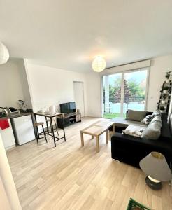 a living room with a couch and a table at Villeneuve, in Villeneuve d'Ascq