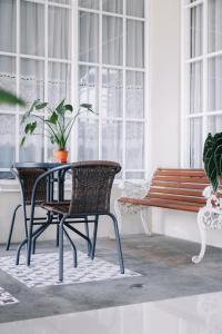 a table and chairs and a bench in a room at HOME 88 Feels Like Home in Sleman