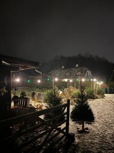 a house with christmas trees in a field at night at Lundtoftegaard in Kongens Lyngby