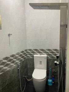 a bathroom with a white toilet in a room at Chandani Hostel in Galle