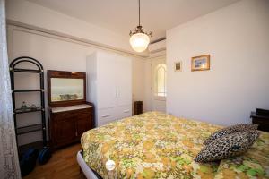 a bedroom with a bed and a dresser and a mirror at Appartamento Diana in Salò