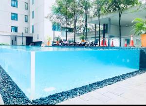 a swimming pool with blue water in front of a building at STAR Hotel Apartment in Kuala Lumpur