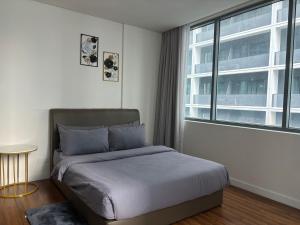 a bedroom with a bed and a large window at STAR Hotel Apartment in Kuala Lumpur +33 photos
