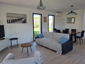 a living room with a couch and a table at Villa U Picculu in Lecci