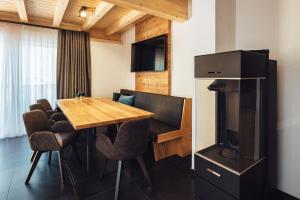 a dining room with a table and a television at Haus Piz Lad in Nauders