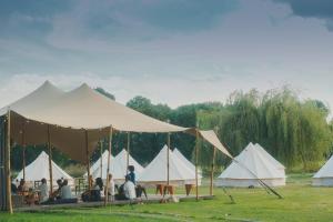 a group of tents with people sitting in them at ASTRAEA Jurt Village in Arendsee