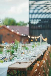 a long table with plates and glasses on it at ASTRAEA Jurt Village in Arendsee