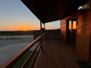 a porch of a house with the sunset in the background at Grape Escape, By Home Match in Palmela