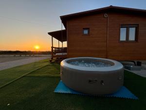 a large tub sitting on the grass in front of a house at Grape Escape, By Home Match in Palmela