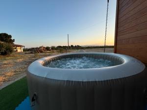 a hot tub with water in it next to a building at Grape Escape, By Home Match in Palmela +22 photos