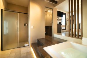 a bathroom with a shower and a bath tub at Le Contrade Di San Salvatore in Monopoli