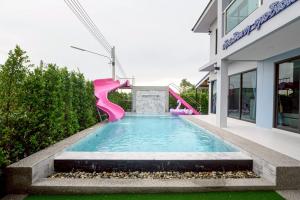 a swimming pool with a pink water slide at BanIngKhao Pool Villa Sriracha in Ban Hup Bon +61 photos