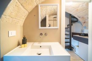 a bathroom with a large white bath tub in a room at Le Contrade Di San Salvatore in Monopoli +97 photos