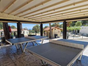 two ping pong tables in a room with windows at Camping de Ceyreste - Maeva in La Ciotat