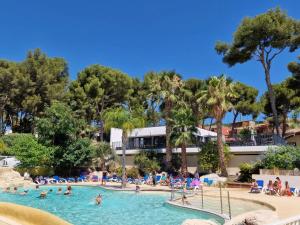 a group of people in a swimming pool at a resort at Camping de Ceyreste - Maeva in La Ciotat