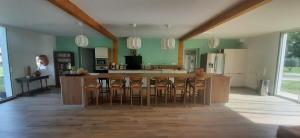 a kitchen with a large island with bar stools at YonShala in Garrosse