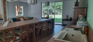 a kitchen with a bar with chairs and a couch at YonShala in Garrosse