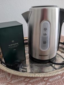 a toaster and a modem sitting on a table at Lägenhet nära naturen Pralinette BB in Nykroppa