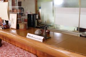 a restaurant counter with a sign on it at ペンション愛宕道 in Kyoto