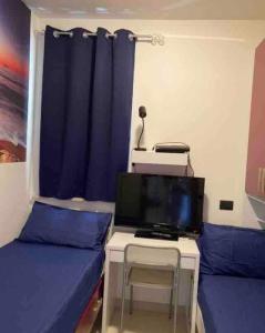 a room with a bed and a table with a tv at Splendida Alba in Tortoreto Lido +33 photos