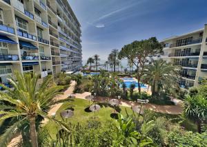 an aerial view of a resort with a pool and palm trees at Skol 216 1Bedroom Duplex First Line Beach in Marbella