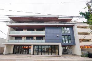 a large blue building with a lot of windows at Pacific Coast Enoshima by Tranova in Fujisawa +113 photos
