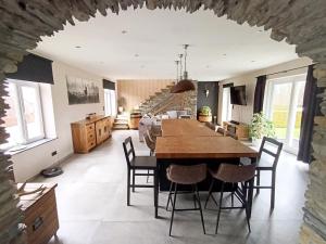 a kitchen and dining room with a table and chairs at Le repaire Ardennais in Rossart