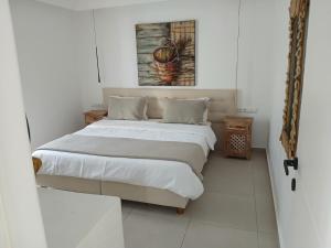 a bedroom with a bed and a painting on the wall at Melissa in Naousa