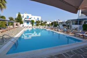 a large swimming pool with blue water in a resort at Melissa in Naousa