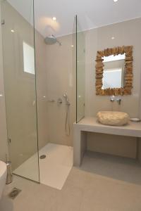 a bathroom with a glass shower and a sink at Melissa in Naousa +15 photos