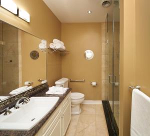 a bathroom with a sink and a toilet and a shower at Greaves Sweet Escape in Niagara on the Lake