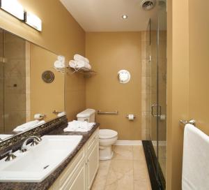 a bathroom with a sink and a toilet and a shower at Greaves Sweet Escape in Niagara-on-the-Lake