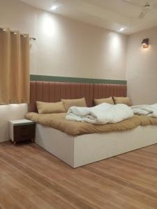 a bedroom with a large bed in a room at Amol resort in Vidisha