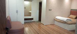a room with a bed and a bathroom with a mirror at Amol resort in Vidisha