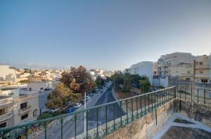 a view of a city from a balcony at Charming Central 2BR Townhouse with Rooftop Terrace in St. Julianʼs