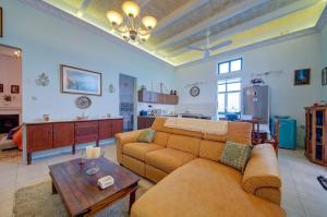 a living room with a couch and a table at Charming Central 2BR Townhouse with Rooftop Terrace in St. Julianʼs
