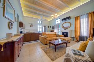 a living room with a couch and a table at Charming Central 2BR Townhouse with Rooftop Terrace in St. Julianʼs +30 photos
