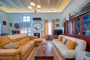 a living room with a couch and a table at Charming Central 2BR Townhouse with Rooftop Terrace in St. Julianʼs