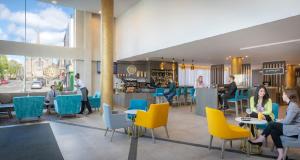 a rendering of a restaurant with people sitting at tables and chairs at Maldron Hotel Parnell Square Dublin City in Dublin