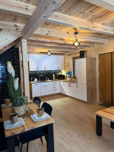 an open kitchen and dining room with a table and chairs at Perła Kaszub in Wiele