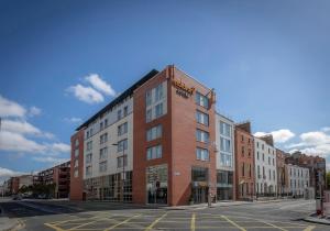 a large brick building on a city street at Maldron Hotel Parnell Square Dublin City in Dublin