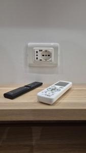 a remote control sitting on a counter next to a controller at Anzio Central Apartments in Anzio