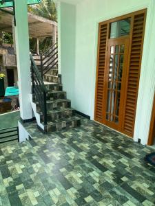 aoyer of a house with a staircase and a door at Chandani Hostel in Galle
