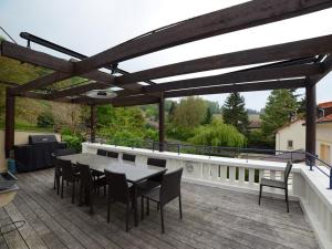 a patio with a table and chairs on a deck at VOIRIN Valérie in Cramant
