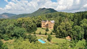 an aerial view of a house in the middle of a forest at Majordoms - Castell de Villavecchia - 33 pax in Sant Hilari Sacalm