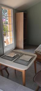 a kitchen with a table in a room at Studio bois du bournat piscine et tranquilité in Saint-Avit-Sénieur