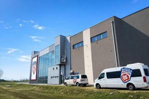 two white vans parked in front of a building at Borsa Rooms in Mostar