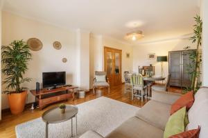 a living room with a couch and a table at Sunny Beachside Escape by Minho's Guest in Póvoa de Varzim