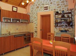 a kitchen with a wooden table and chairs at Menego Lodge Bol in Bol